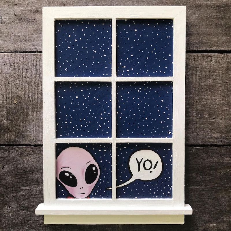 An alien looking in a window.
