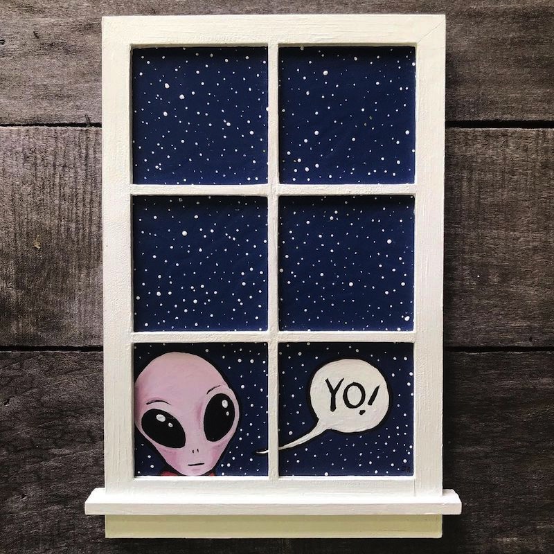 An alien looking in a window.